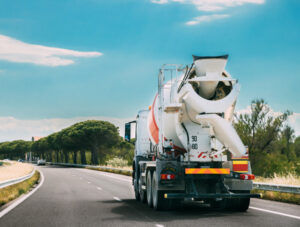 Concrete Transport Truck In transit Mixer Unit In Motion On Coun